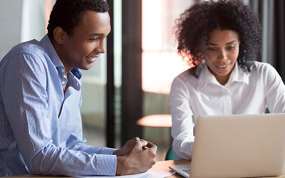 Mentorship feature image, Mixed-race mentor manager consulting african client teaching employee with laptop